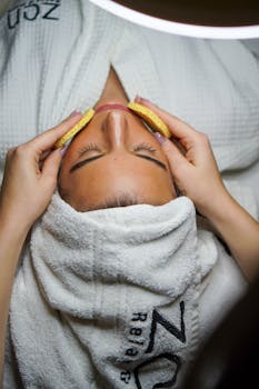 Relaxing spa treatment with facial and sponge massage in a serene environment.